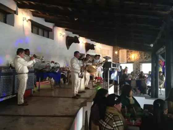 Mariachi tocando en un salón con invitados